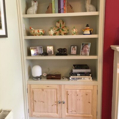 White painted alcove shelving and cupboard unit