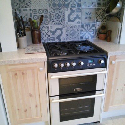 Pine shaker style kitchen cupboard doors around an oven